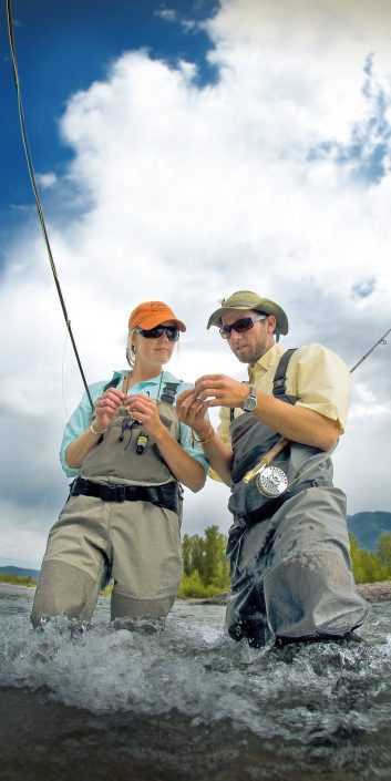 Outdoor Lifestyle Photography ~ Fishing guide tying a fly for a client ~ shot for Glacier Country Tourism.